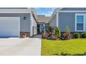 View of the landscaped front entrance, with colorful flowers and wrought iron gating to the front door at 4053 Taranto Loop # C, Myrtle Beach, SC 29579