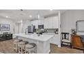 Bright kitchen featuring white cabinets, stainless appliances, large island, and modern pendant lighting at 4053 Taranto Loop # C, Myrtle Beach, SC 29579