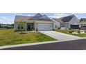 Well-maintained single story home with an attached two-car garage and front lawn with minimal landscaping at 4449 Honir Dr., Myrtle Beach, SC 29579