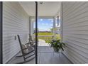 Cozy screened-in porch featuring a rocking chair and view of the neighborhood at 4449 Honir Dr., Myrtle Beach, SC 29579