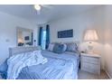 Comfortable bedroom with serene blue bedding, complemented by natural light and neutral decor for a calming retreat at 4486 Little River Inn Ln. # 2107, Little River, SC 29566