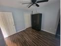 A cozy bedroom featuring wood flooring, a ceiling fan, and closet space at 477 White River Dr. # 32-H, Myrtle Beach, SC 29579