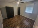 A bright bedroom with wood flooring, a ceiling fan and closet space at 477 White River Dr. # 32-H, Myrtle Beach, SC 29579