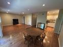 Living room featuring hardwood floors, a dining table, TV stand, and access to the kitchen area at 5001 Little River Rd. # W-211, Myrtle Beach, SC 29577