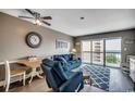 Comfortable living room boasts water views and furnished with a plush blue sofa and chair at 7500 N Ocean Blvd. # 6061, Myrtle Beach, SC 29572