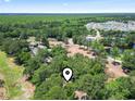 Aerial view of a lush neighborhood in a wooded area with a pond at 752 Tall Oaks Ct., Myrtle Beach, SC 29588