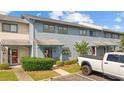 Charming townhouse with blue siding, landscaped front yard, and parking spot in front at 775 Plantation Dr. # 28, Little River, SC 29566