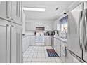 Bright and clean white kitchen featuring stainless steel appliances and tile flooring at 775 Plantation Dr. # 28, Little River, SC 29566