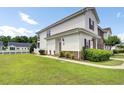 Inviting townhome featuring a well-maintained lawn, attached garage, and a serene residential setting at 8855 Radcliff Dr. Nw # 53C, Calabash, NC 28467
