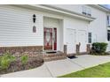 Inviting entryway with a decorative door, brick steps, and convenient storage units at 8855 Radcliff Dr. Nw # 53D, Calabash, NC 28467