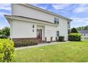 Well-maintained home featuring white siding, brick accents, and a lush green lawn at 8855 Radcliff Dr. Nw # 53D, Calabash, NC 28467