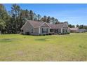 The house features a lush lawn, complementing the home's siding and landscaping at 95 Timber Run Dr., Georgetown, SC 29440