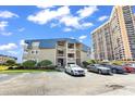 View of the Seagull condominium complex next to a high rise, with ample parking at 9660 Shore Dr. # 208, Myrtle Beach, SC 29572
