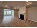 Bright living room featuring a fireplace, tray ceilings, and a sunroom at 1241 Beeblossom Dr., North Myrtle Beach, SC 29582