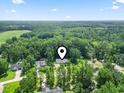 Aerial view of a neighborhood surrounded by green forests with homes nestled in the trees at 125 Gavin Hill Ct., Aynor, SC 29511