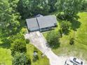 Aerial view of a cozy home nestled among lush trees and a long driveway at 125 Gavin Hill Ct., Aynor, SC 29511