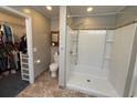 Bathroom featuring walk-in closet, toilet, and a shower with tile surround at 125 Gavin Hill Ct., Aynor, SC 29511