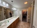Spacious bathroom featuring a dual sink vanity, large mirror, and convenient walk-in closet at 125 Gavin Hill Ct., Aynor, SC 29511