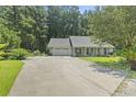 Well-maintained single-story home with a long driveway and mature landscaping at 125 Gavin Hill Ct., Aynor, SC 29511