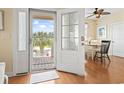 Bright foyer with decorative glass front door and dining area view at 128 Lake Pointe Dr., Murrells Inlet, SC 29576