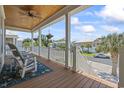Relaxing porch area with ceiling fan, views of the neighborhood, and rocking chair at 128 Lake Pointe Dr., Murrells Inlet, SC 29576