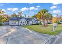 Well maintained brick home with an extended driveway and mature landscaping at 156 Hummingbird Ct., Myrtle Beach, SC 29579