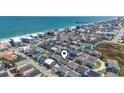Aerial view showing a home's proximity to the beach and the surrounding coastal community at 161 Easy St., Garden City Beach, SC 29576