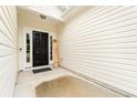 Welcoming front door entrance with a 'Welcome' sign and vinyl siding at 1620 San Andres Ave., Little River, SC 29566