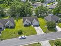 An aerial view shows a neighborhood with houses, trees, and landscaping, and a street with one car at 176 Whispering Oaks Dr., Longs, SC 29568