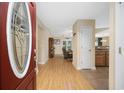 Inviting foyer featuring hardwood floors and an arched doorway to living area at 208 Hamilton Way, Conway, SC 29526