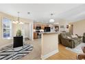 Open kitchen featuring stainless steel appliances, a breakfast bar, and tile floors at 208 Hamilton Way, Conway, SC 29526