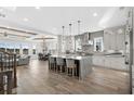 Open-concept kitchen with modern island, stainless steel appliances, and an adjacent living area at 208 W Palms Dr., Myrtle Beach, SC 29579