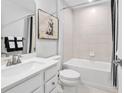 Bright bathroom featuring white cabinetry, shower/tub combo, and decorative artwork at 2616 Elowen Ln. # 167B, Longs, SC 29568