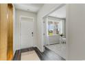 Bright entryway featuring a white front door, modern flooring, and view into the front room at 2851 Riverboat Way, Conway, SC 29526