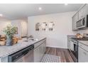 Well-lit kitchen with stainless steel appliances, granite countertops, and a view into the dining area at 2889 Riverboat Way, Conway, SC 29526