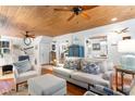 Open living room with wood plank ceiling, fireplace, and a cozy seating arrangement at 309 Sunset Trail, Myrtle Beach, SC 29577