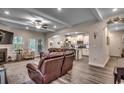 Spacious living room featuring hardwood floors, fireplace, and open floor plan to kitchen at 3091 Viceroy Loop, Little River, SC 29566
