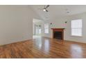 Spacious living room featuring wood floors, vaulted ceiling, and a fireplace at 316 Watercress Dr., Longs, SC 29568