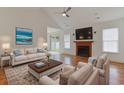 Bright living room with hardwood floors, fireplace, and access to the backyard at 316 Watercress Dr., Longs, SC 29568