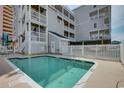 Community pool area with privacy fence and pool equipment at 3401 N Ocean Blvd. # 302, North Myrtle Beach, SC 29582
