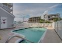 Community pool area with privacy fence and lounge chairs at 3401 N Ocean Blvd. # 302, North Myrtle Beach, SC 29582