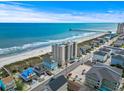 Aerial view of a beachfront condo with beautiful ocean views, a pier, and nearby restaurants at 4000 N Ocean Blvd. # 506, North Myrtle Beach, SC 29582