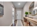 Inviting entryway with wood floors, a stylish console table, and a round mirror, creating a warm welcome at 4019 Braid Ct., Myrtle Beach, SC 29588