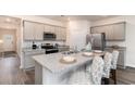 Modern kitchen with granite countertops, stainless steel appliances, and stylish bar stools at 409 Glade Ct., Loris, SC 29569