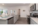 Bright kitchen featuring stainless appliances, granite countertops, and wood flooring at 409 Glade Ct., Loris, SC 29569