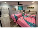 Cozy bedroom featuring two twin beds, a ceiling fan, and a mounted television at 4303 South Ocean Blvd. # 303, North Myrtle Beach, SC 29582