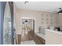 Inviting entryway with hardwood floors, neutral paint, and views into a dining area and another sitting area at 4639 Mandi Ave., Little River, SC 29566