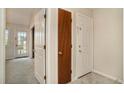 Bright hallway featuring neutral paint, carpet, and an assortment of doors leading to other spaces at 510 Fairwood Lakes Dr. # 18N, Myrtle Beach, SC 29577