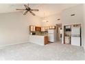 Open floor plan with vaulted ceilings leading to a kitchen and a laundry area with stackable appliances at 510 Fairwood Lakes Dr. # 18N, Myrtle Beach, SC 29577