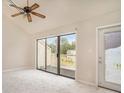 Open living room featuring vaulted ceilings, ceiling fan, sliding glass doors to deck, and neutral carpet at 510 Fairwood Lakes Dr. # 18N, Myrtle Beach, SC 29577